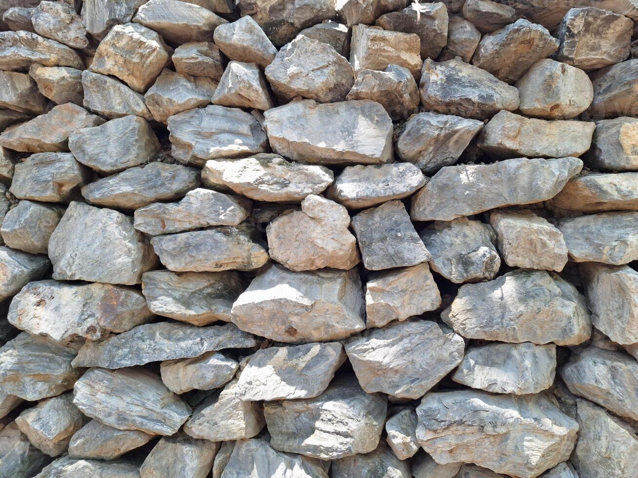 Picture of large rocks stacked together to form a wall photo