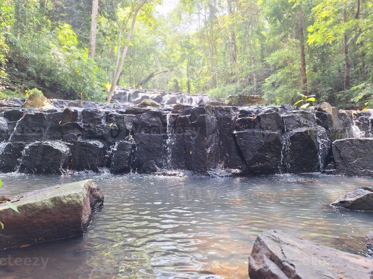 Blurred image of a waterfall in the forest photo