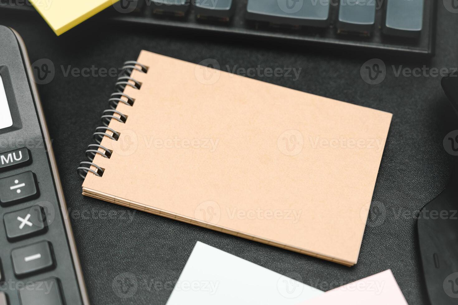 Top view of notebook. Blank paper notepad on office desk table with keyboard and other supplies. Blank notebook page for input the text. copy space, flat lay. photo