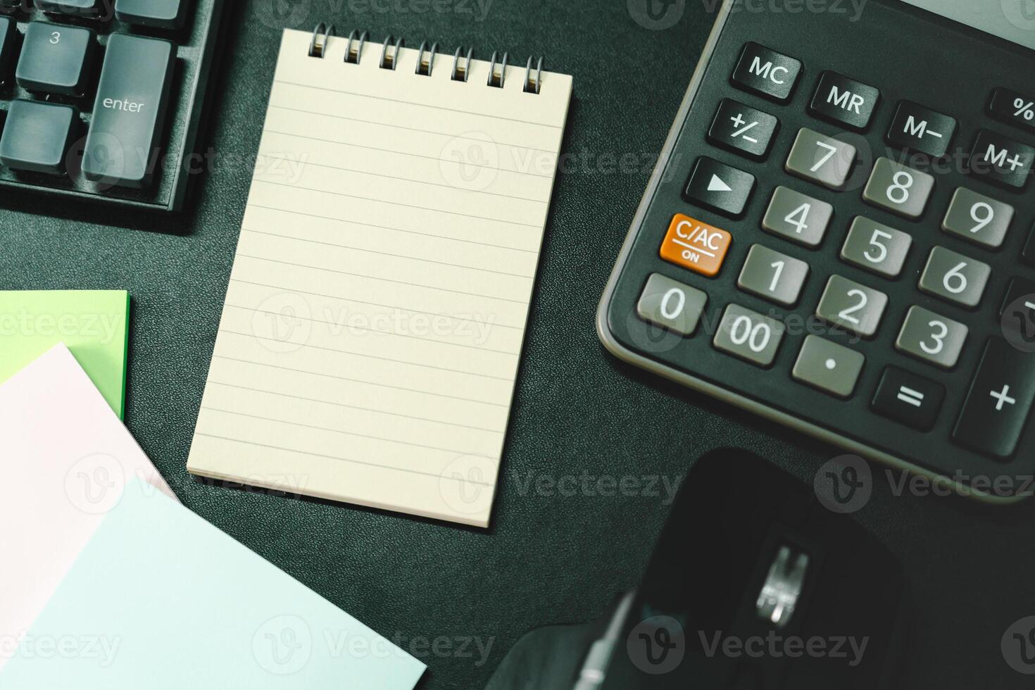Top view of notebook. Blank paper notepad on office desk table with keyboard and other supplies. Blank notebook page for input the text. copy space, flat lay. photo
