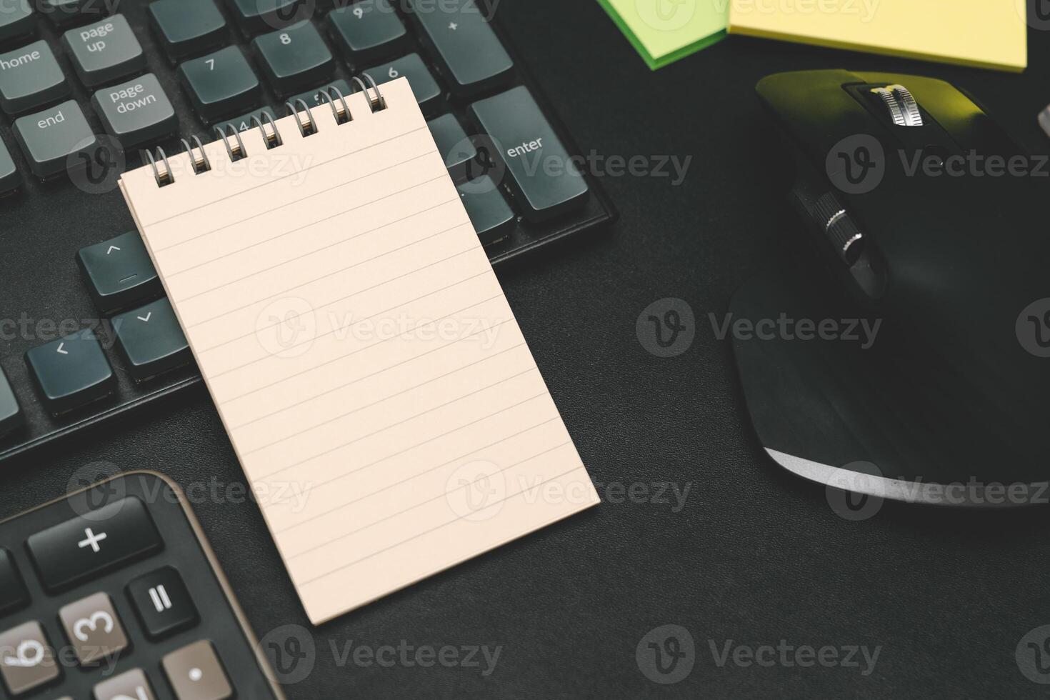 Top view of notebook. Blank paper notepad on office desk table with keyboard and other supplies. Blank notebook page for input the text. copy space, flat lay. photo