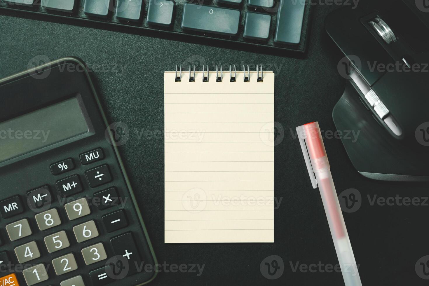 Top view of notebook. Blank paper notepad on office desk table with keyboard and other supplies. Blank notebook page for input the text. copy space, flat lay. photo