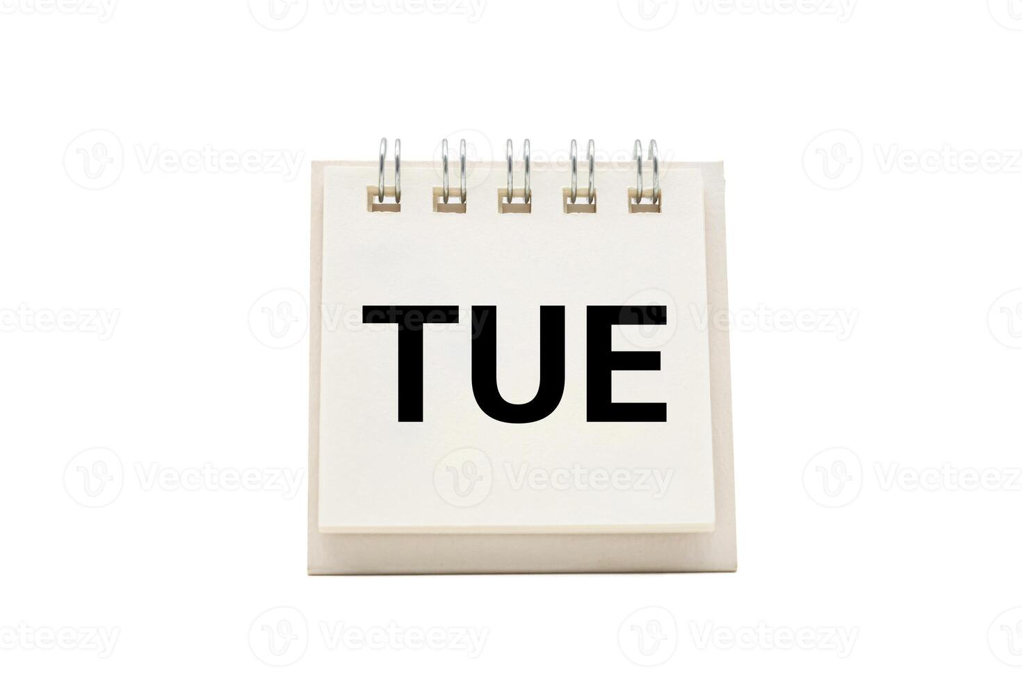 TUE text on desk calendar with clipping path isolated on white background. TUESDAY and Calendar concept photo