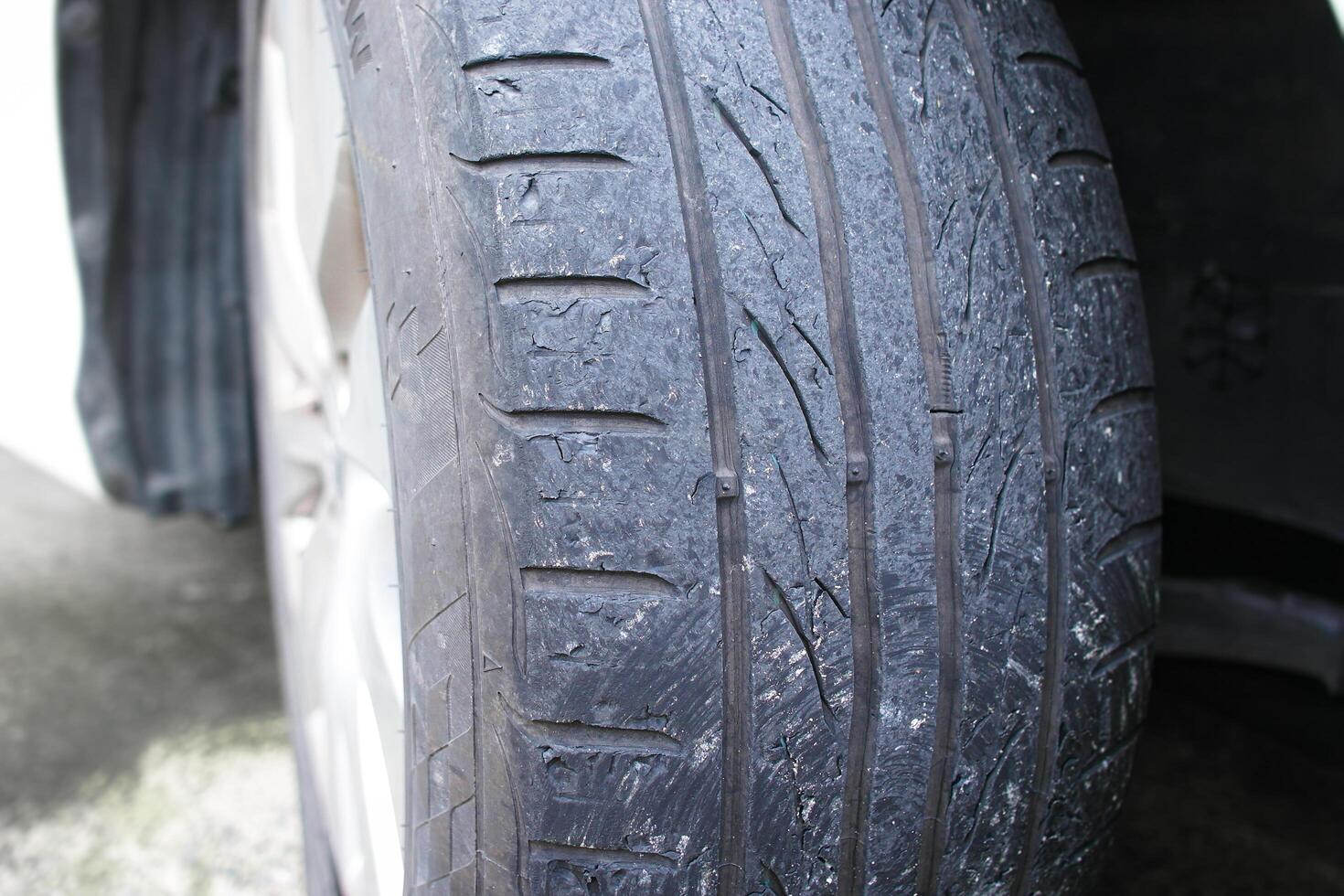 Close up of car tire tread deterioration from use , worn out a car tire , Car maintenance concept photo