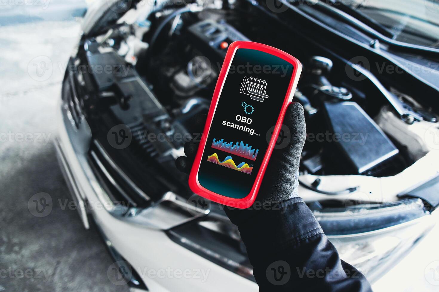 OBD scanner tools , OBD Scanner in use by mechanic over car engine background for analysis engine system problems , Car repair concept photo