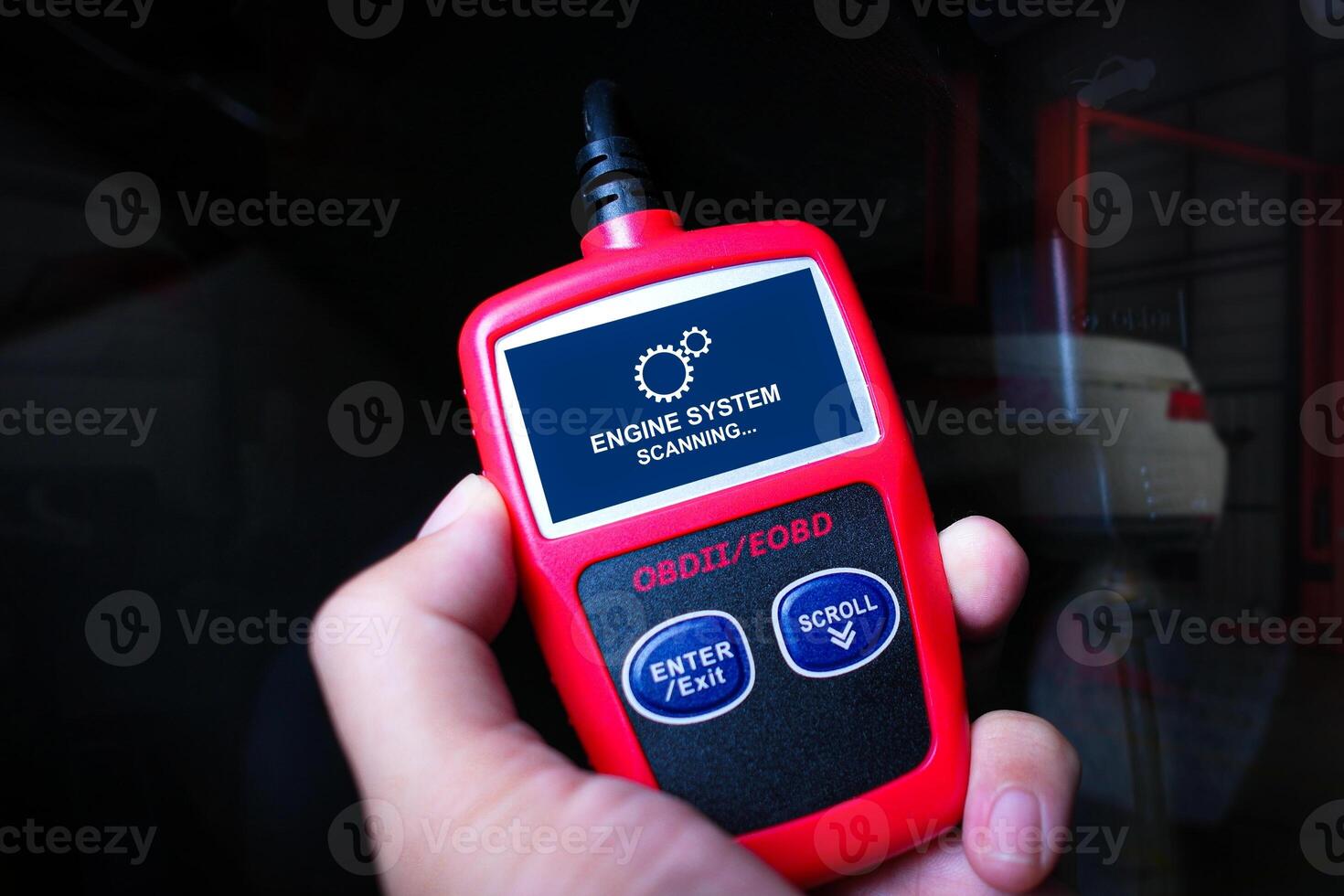 Handheld engine diagnostic obd tool in use for car fixing , Car repair concept photo