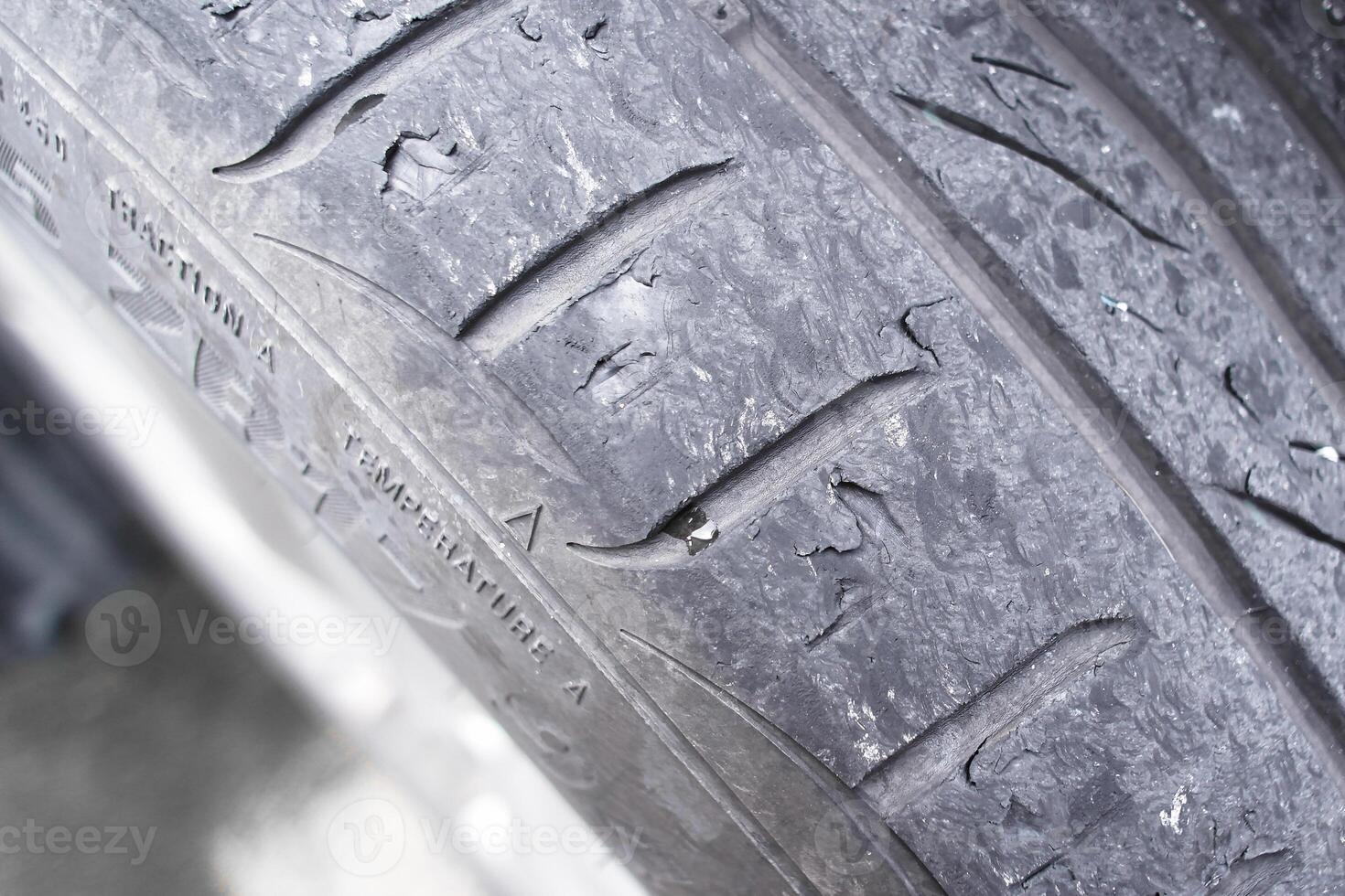 Close up of car tire tread deterioration from use , worn out a car tire , Car maintenance concept photo
