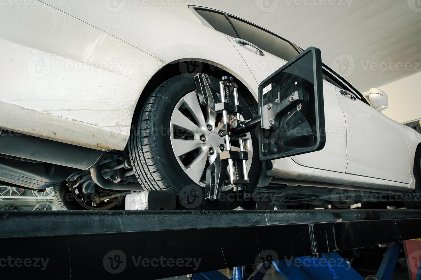 Vehicle wheel alignment with standard wheel alignment machine in auto repair shop , Car maintenance concept photo