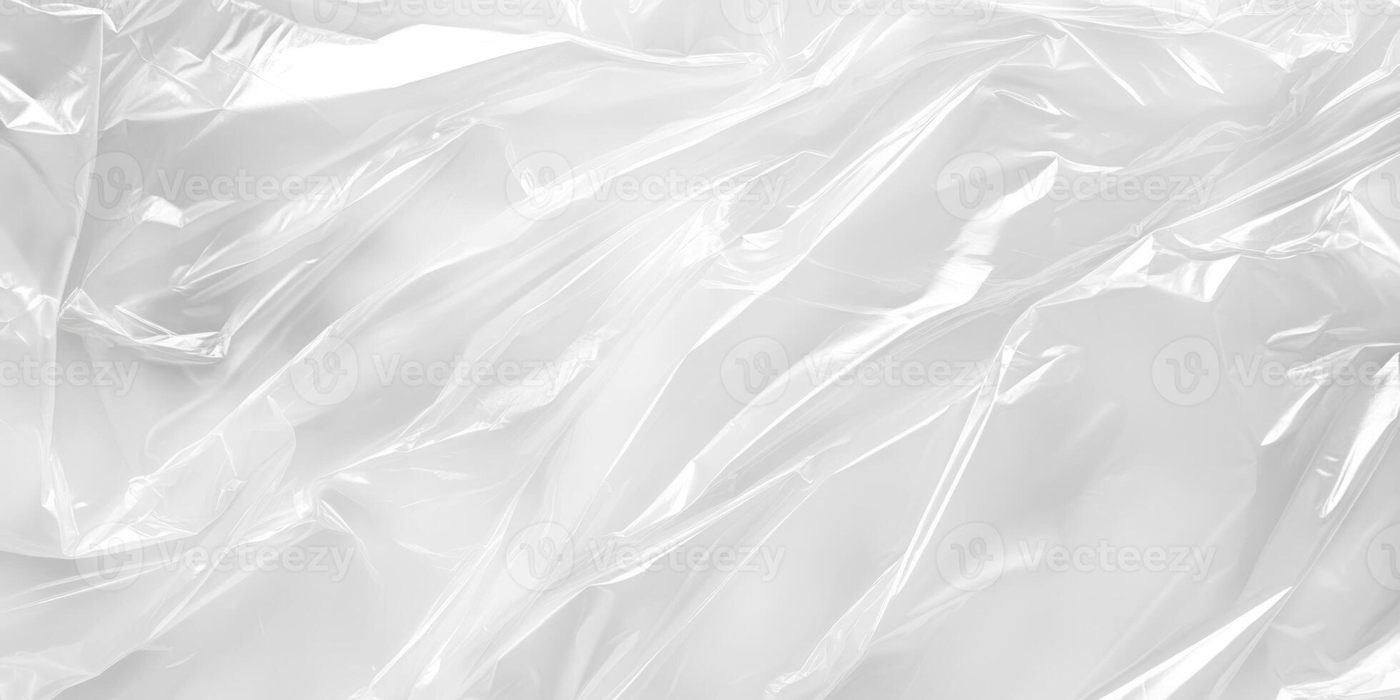 This closeup photo of a crumpled transparent plastic highlights its texture and sheen, making it ideal for backgrounds, packaging, and designs. The light and shadows enhance its visual appeal