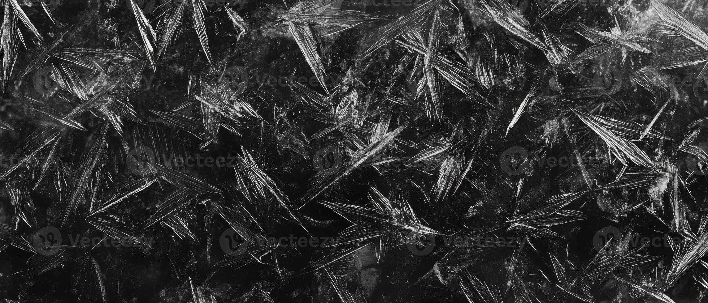 A detailed closeup of a frosty polycarbonate surface reveals intricate and captivating ice crystal patterns, evoking the chilly atmosphere and mesmerizing beauty that is characteristic of winter photo
