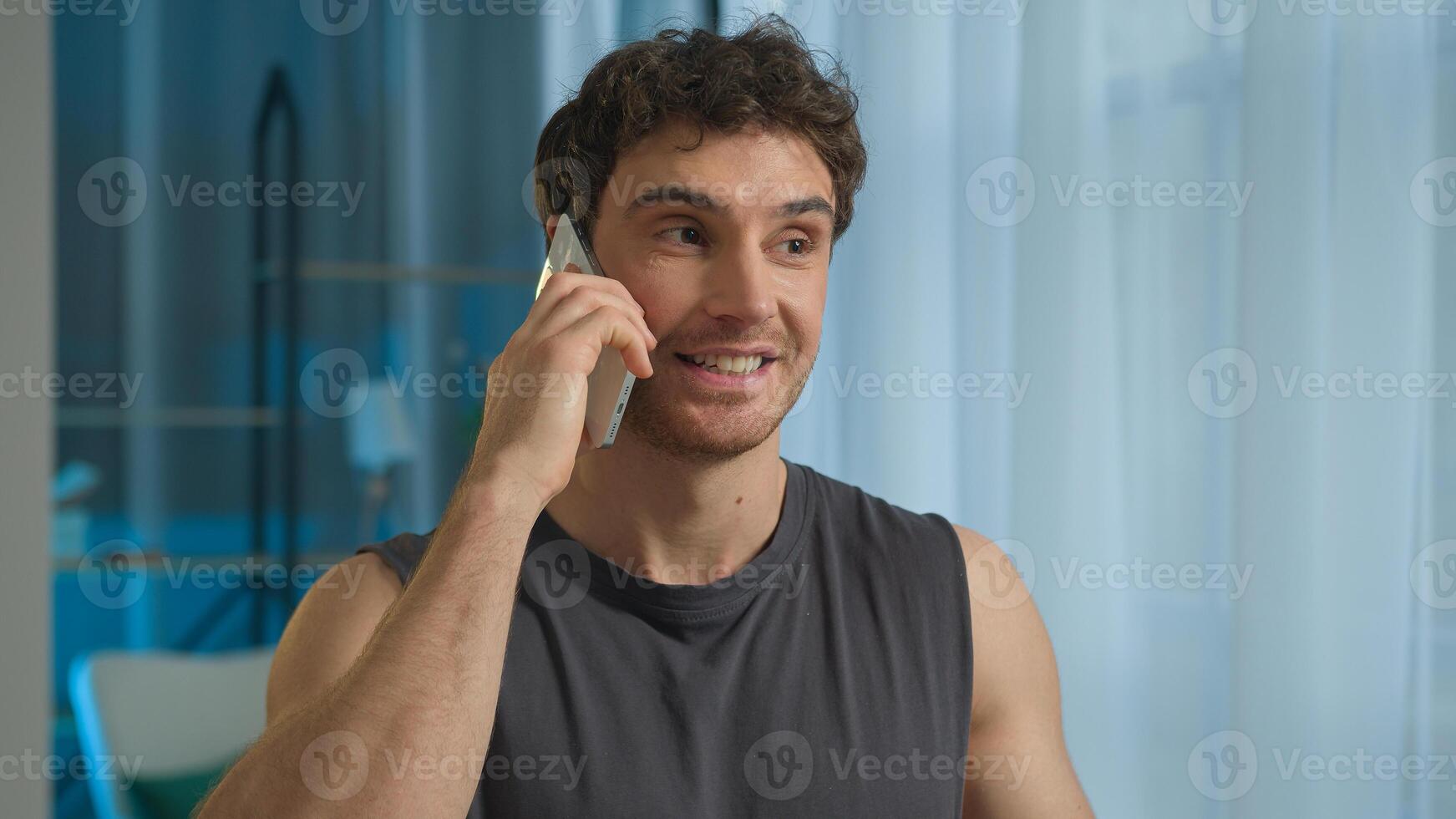 Caucasian European man guy happy male athlete sportsman talking mobile phone smartphone order delivery communication electronic device smiling cheerful bodybuilder muscular technology chatting call photo