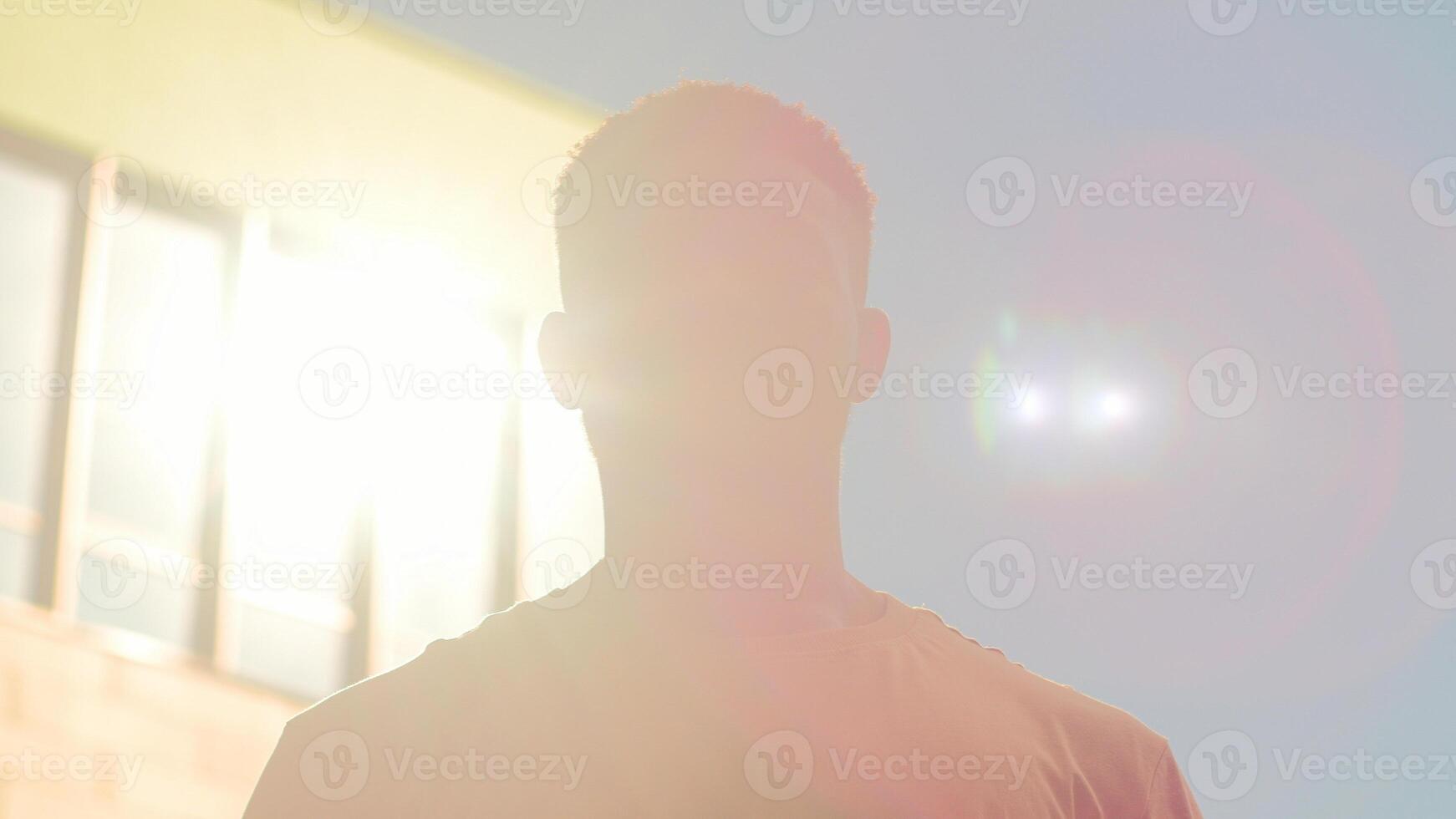 Portrait confident serious African American man outdoors in city looking at camera guy male student businessman business worker tourist hipster in sun shine sunbeams sunny background people headshot photo