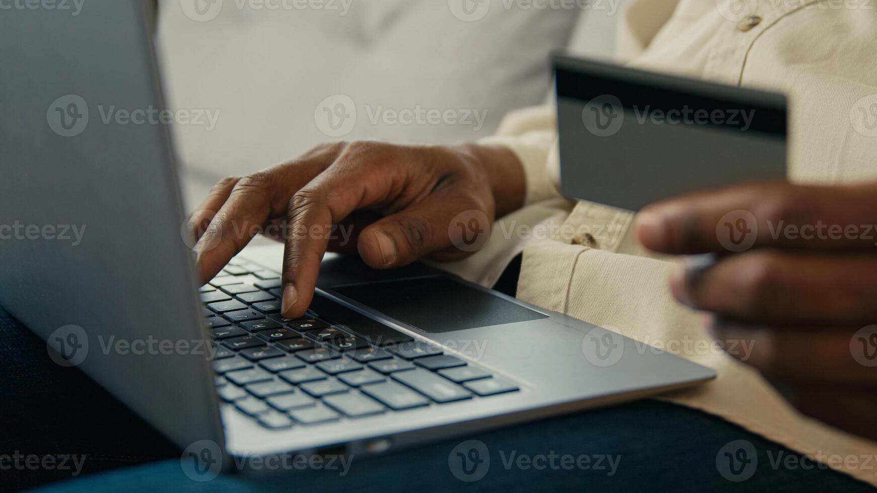 Close-up male hands man customer buyer holding credit card making purchase paying using banking electronic computer application in online store on laptop remote pay for delivery makes secure payment photo