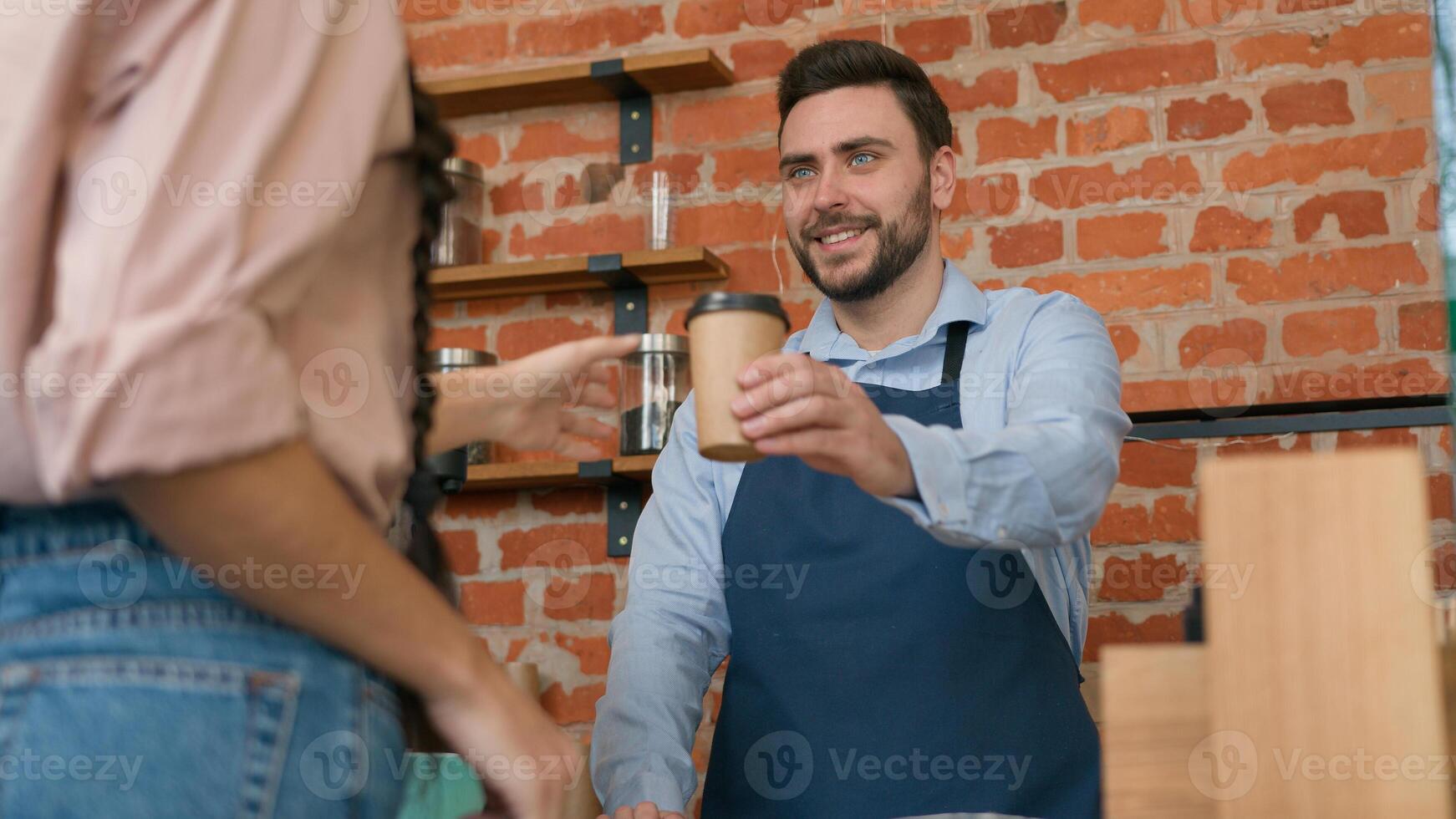Woman customer pay use contactless payment technology NFC on phone in cafe bar restaurant smiling man waiter barista serving client at counter in cafeteria girl paying through bank mobile app terminal photo