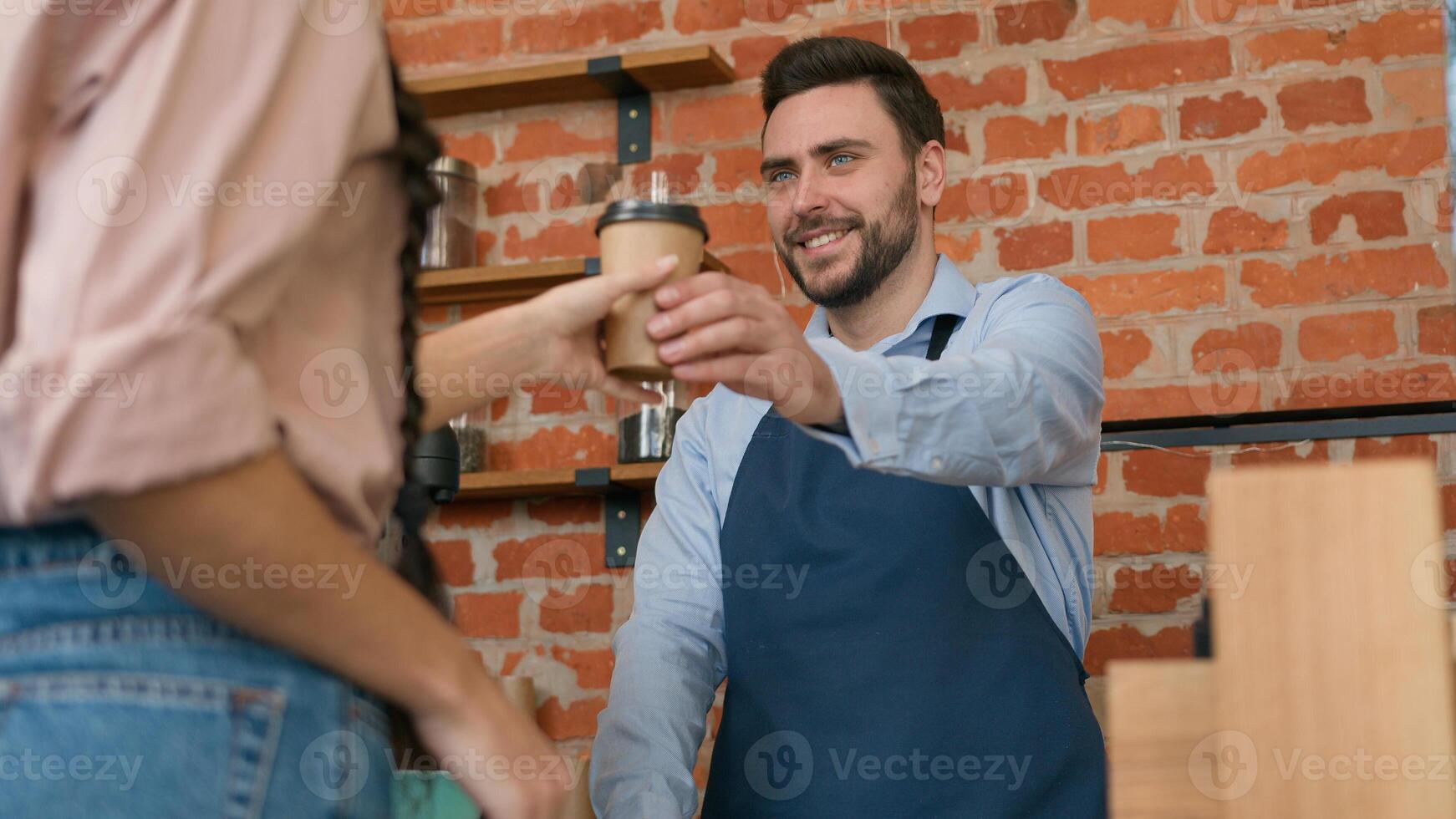 Woman customer pay use contactless payment technology NFC on phone in cafe bar restaurant smiling man waiter barista serving client at counter in cafeteria girl paying through bank mobile app terminal photo