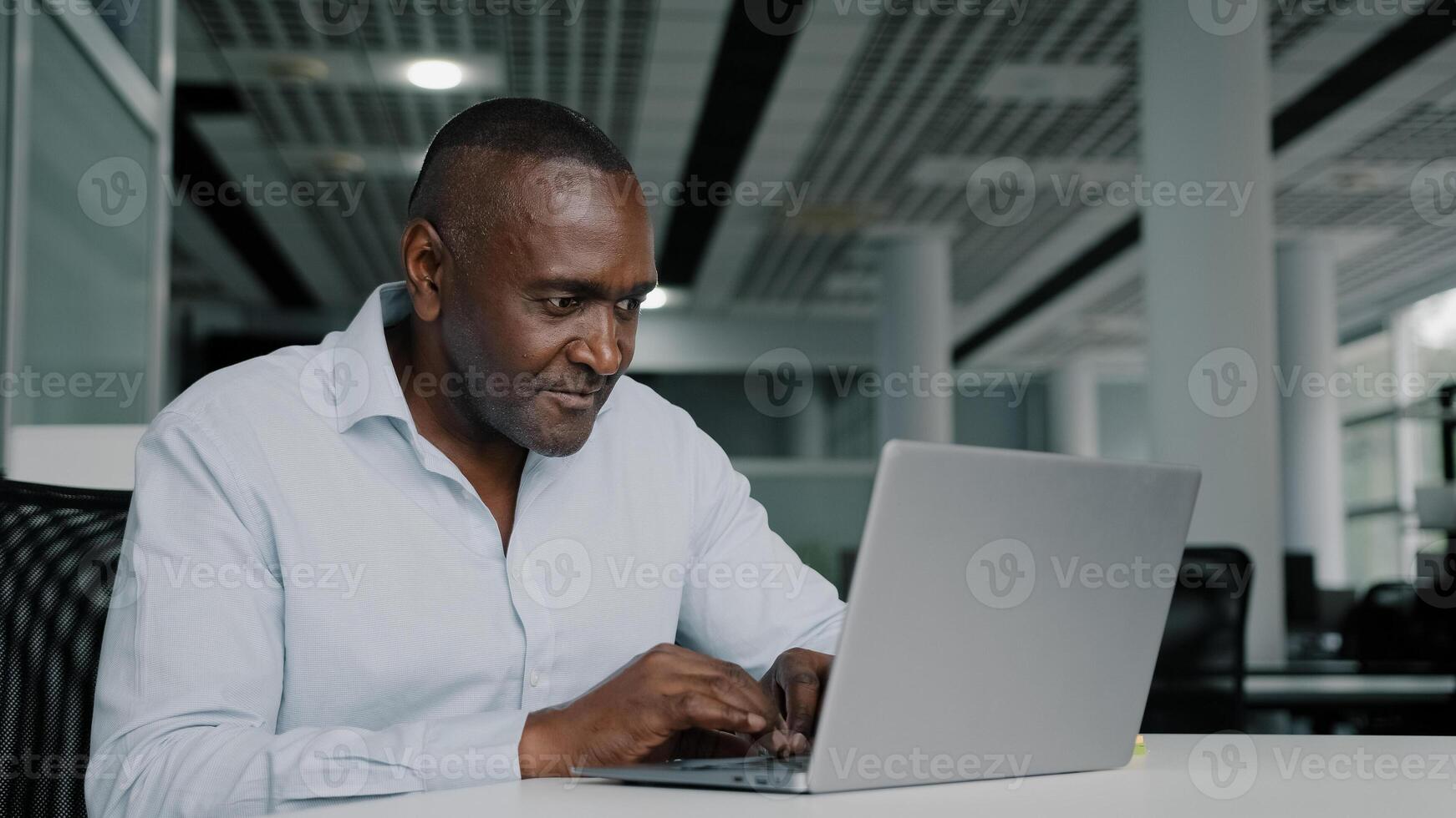 African american businessman work on laptop at office chatting online young woman trainee come to adult colleague analyze startup internet project approve commercial idea thumb up agreeing shake hands photo