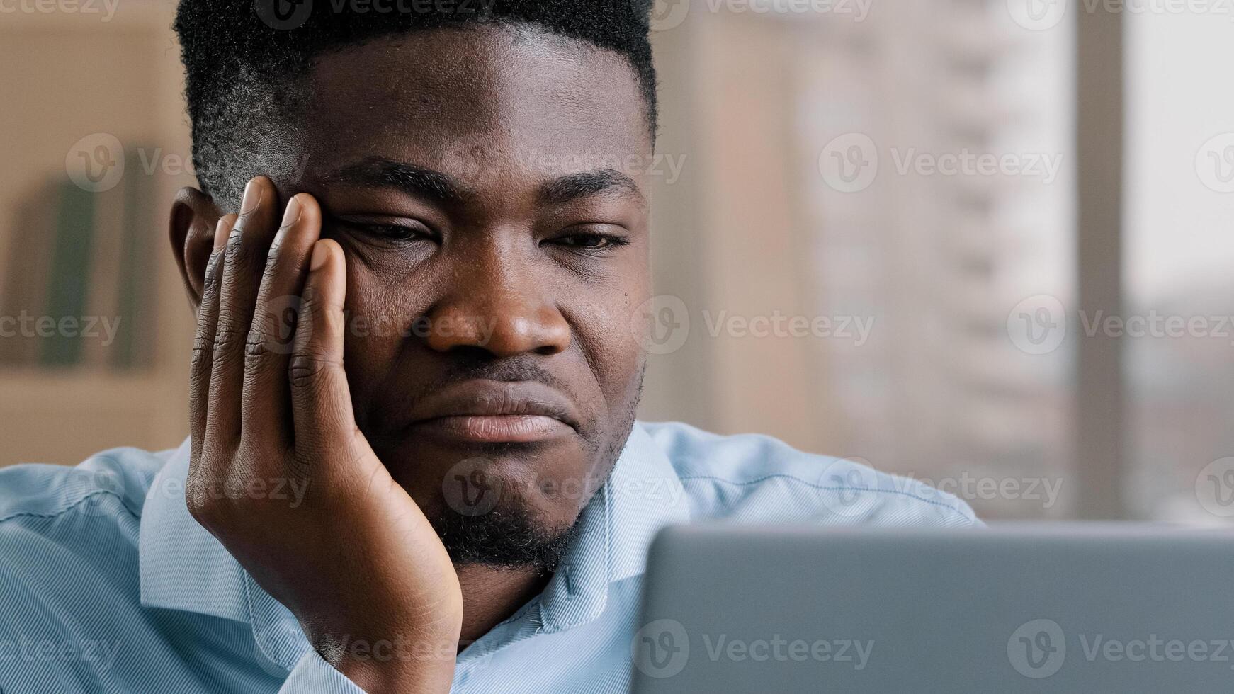 Bored disappointed african man american male businessman have sleeping problem lazy young exhausted guy slumber rest at home workplace feel passive emotion tired from monotone online work at computer photo