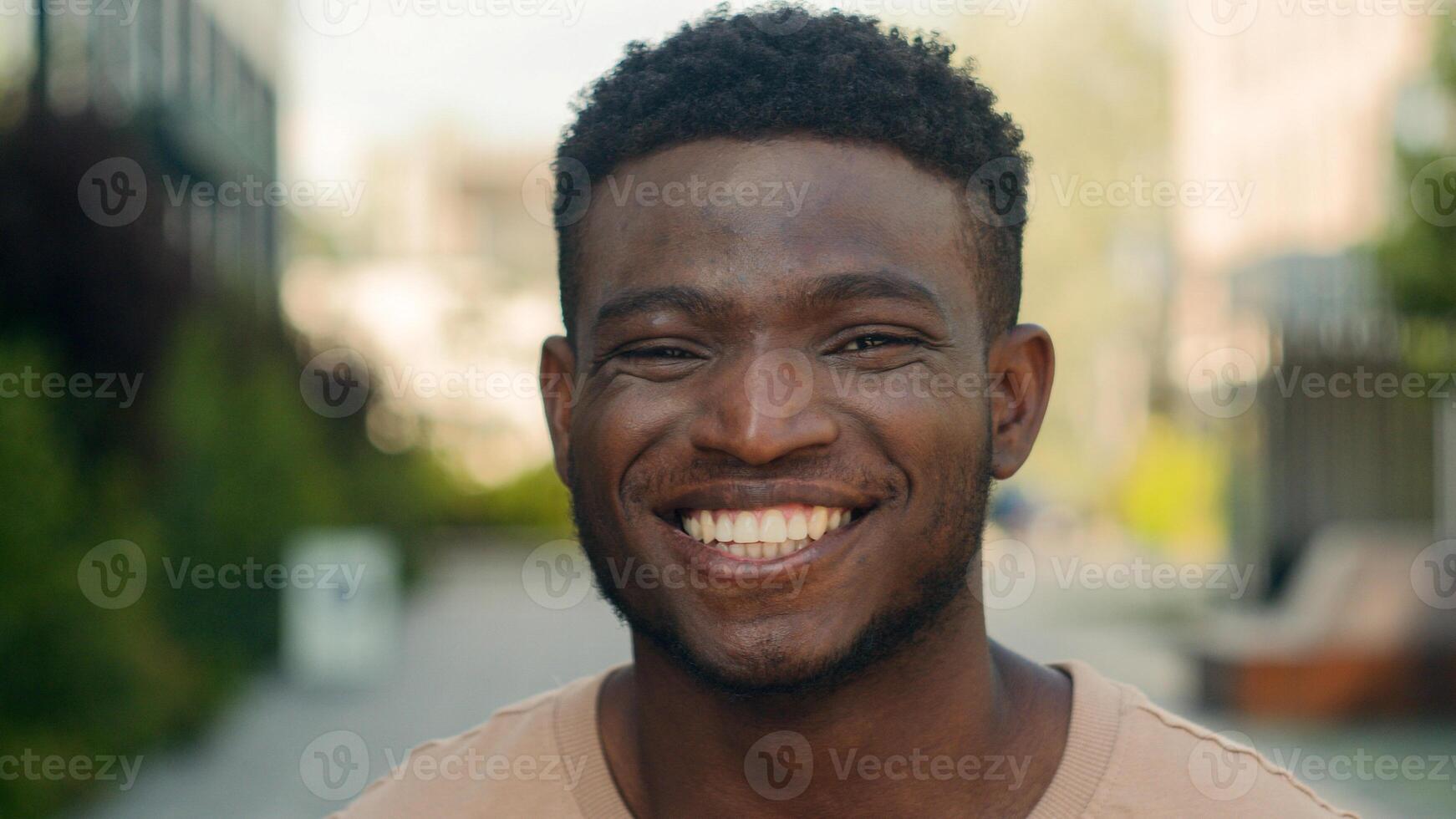 Close up male face happiness expression portrait African American happy smiling guy in city laugh funny reaction enjoy biracial man smile toothy white teeth dental service dentistry medicine outdoors photo