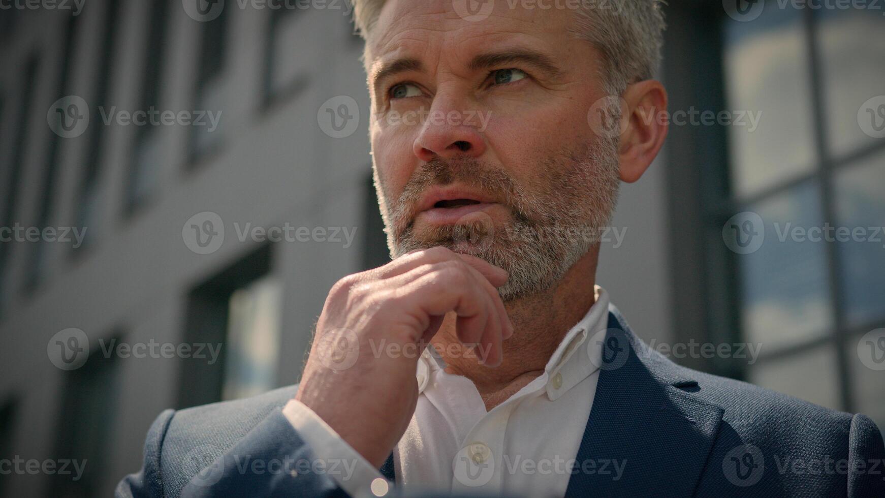 Caucasian senior pensive thinking mature businessman smartphone using mobile application mature thoughtful business man looking at cell phone working check online digital data corporate tech in city photo