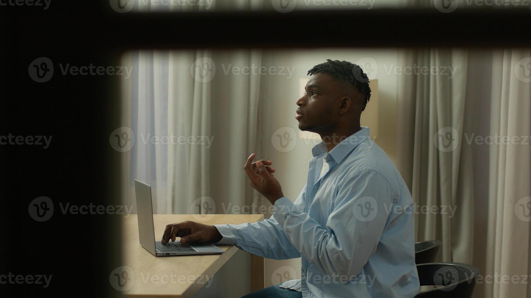 POV spy point of view African American man guy male user freelancer student business man working business late night evening at home thinking pensive typing laptop think solving problem author work photo