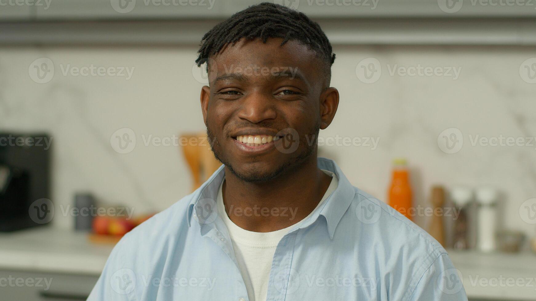 Happy smiling portrait male ethnic healthy homeowner householder renter positive toothy smile African American man guy home kitchen rental real estate mortgage insurance loan food delivery apartment photo