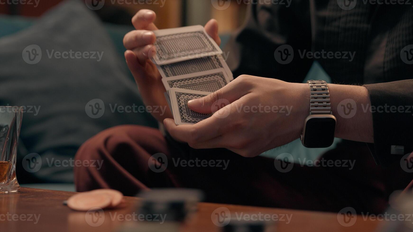 Unrecognizable Caucasian man dealer gamer croupier guy male hands shuffles playing cards shuffling card betting play game strategy luck poker tournament indoors living room casino. Gambling addiction photo