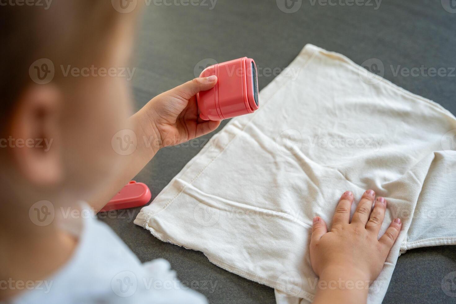 Back view of little girl with a stamp with a name for signing children's things. Identification of personal clothing. High quality photo