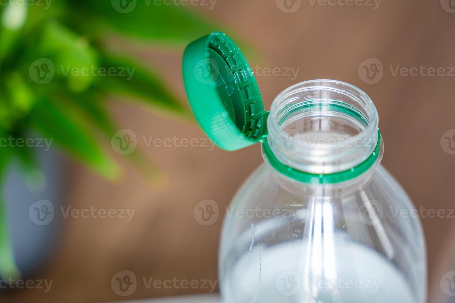 Stationary plastic cap on a PET bottle. The new design means the cap remains attached to the bottle after opening, making the entire package easier to collect and recycle. High quality photo
