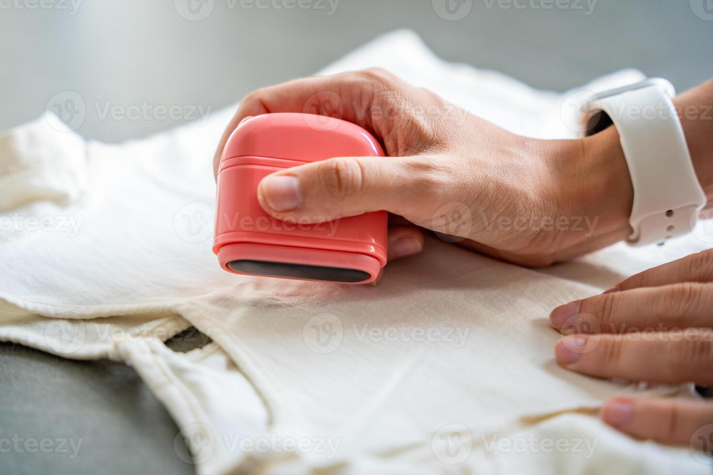 Close-up view of woman's hands with a stamp with a name for signing children's things. Identification of personal clothing. High quality photo