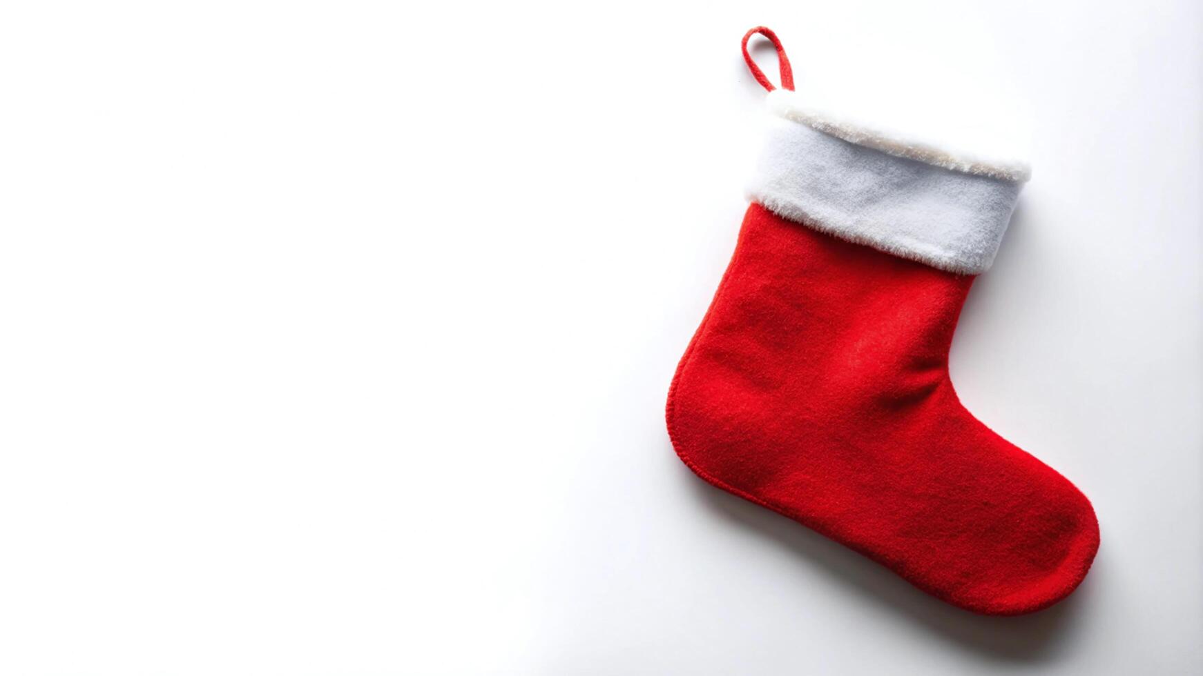 Single Red Christmas Stocking Against White Background photo