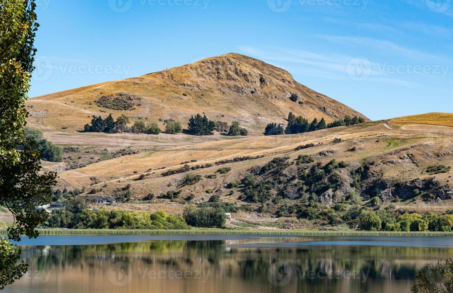 Gorgeous views of lake hayes in New zealand clear day hills photo
