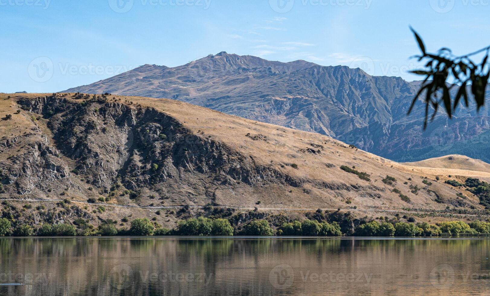 Gorgeous views of lake hayes in New zealand clear day hills photo