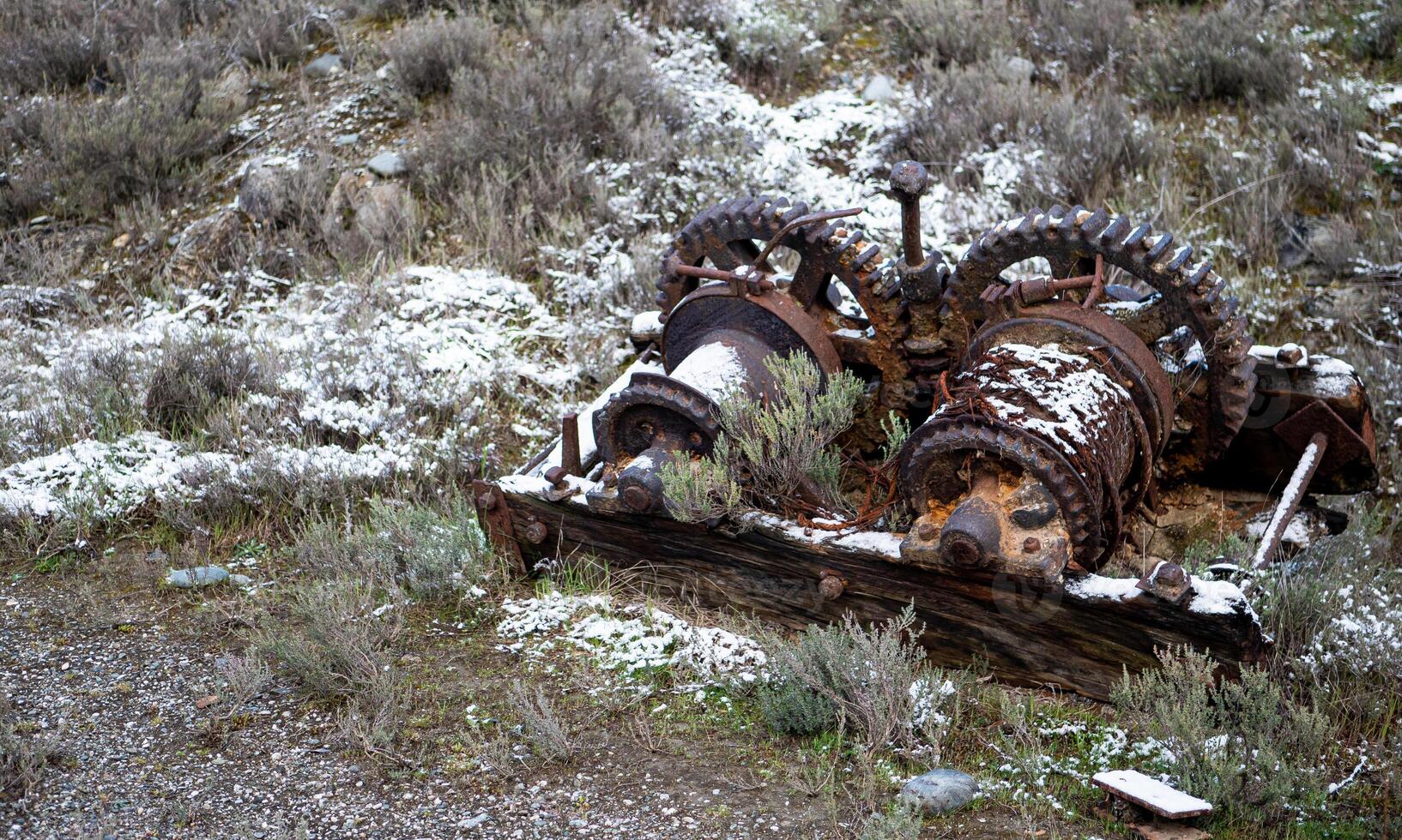 Old rusty machinery abandoned covered in snow frost photo