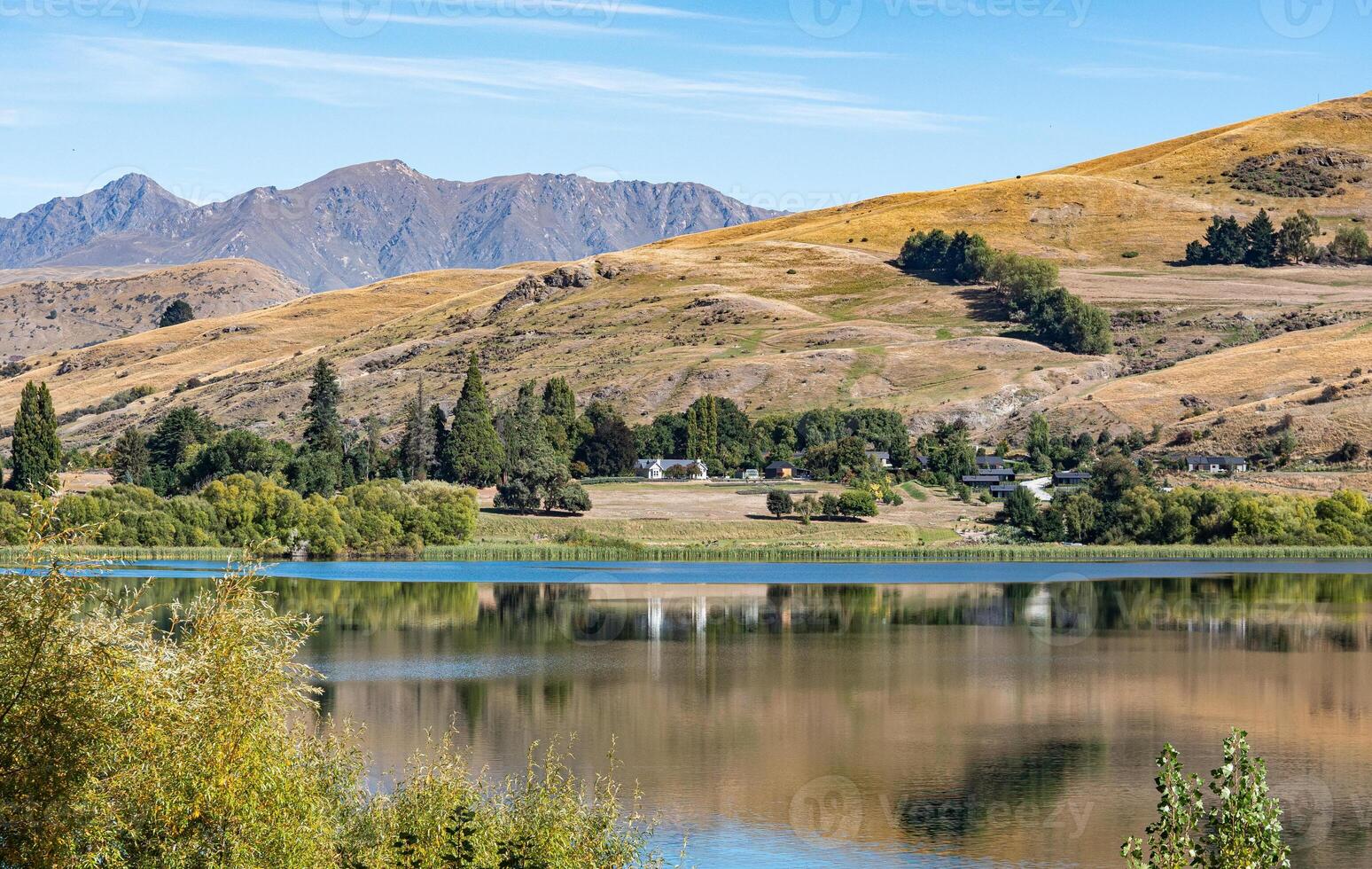 Gorgeous views of lake hayes in New zealand clear day hills photo