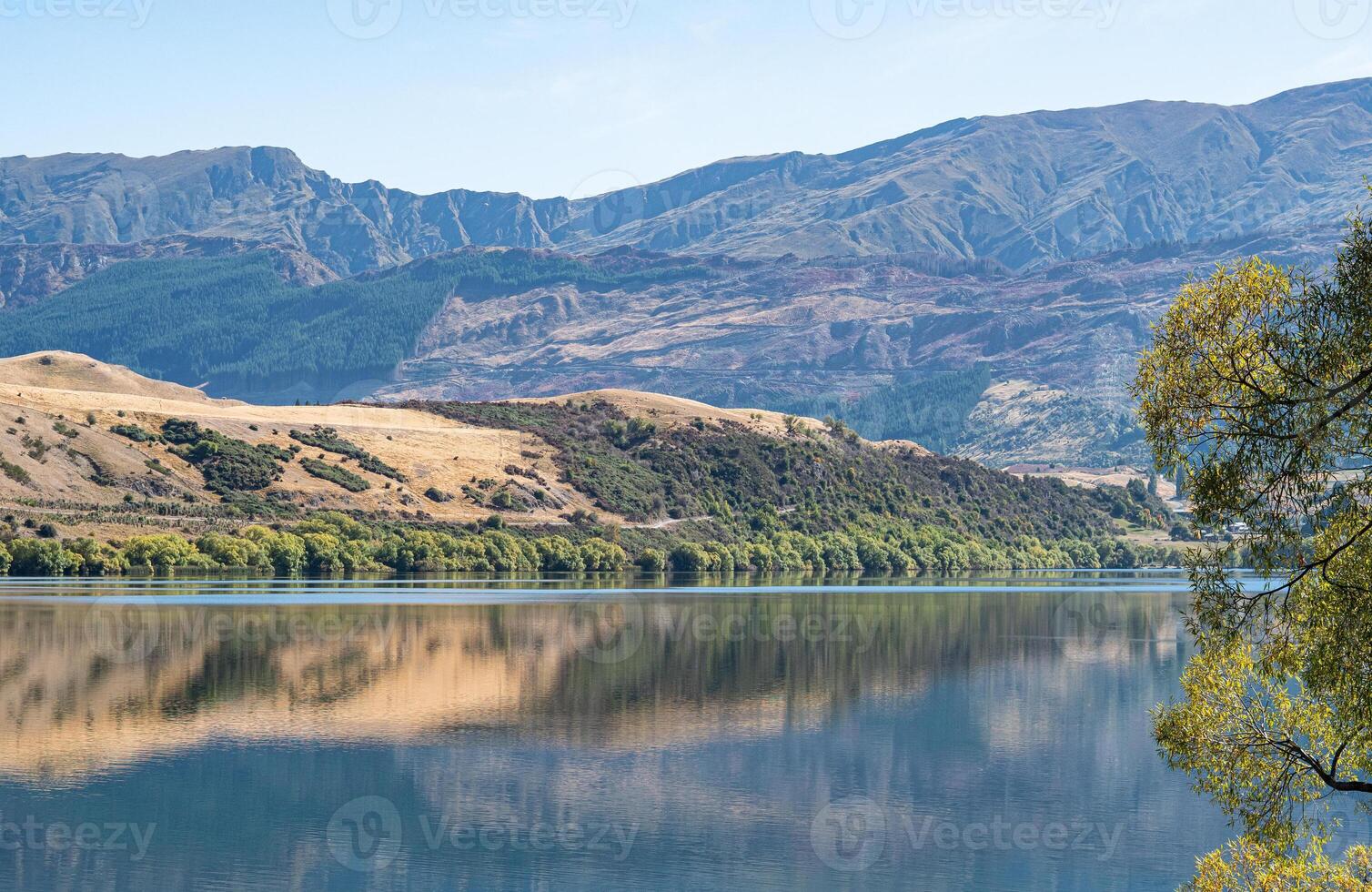 Gorgeous views of lake hayes in New zealand clear day hills photo