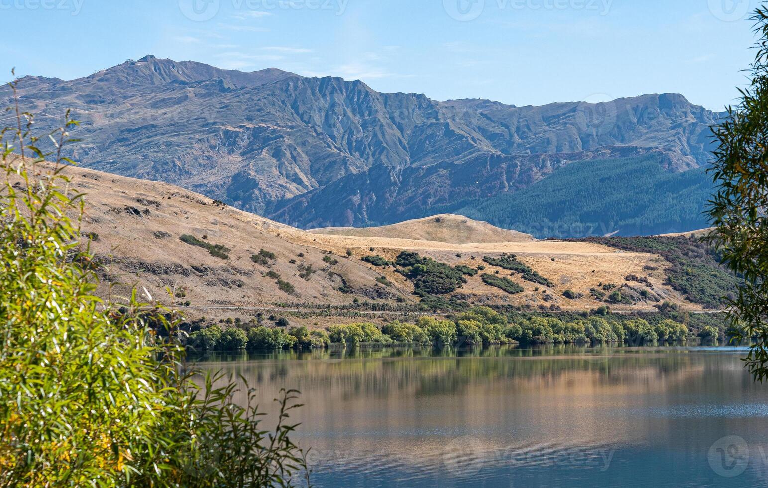 Gorgeous views of lake hayes in New zealand clear day hills photo