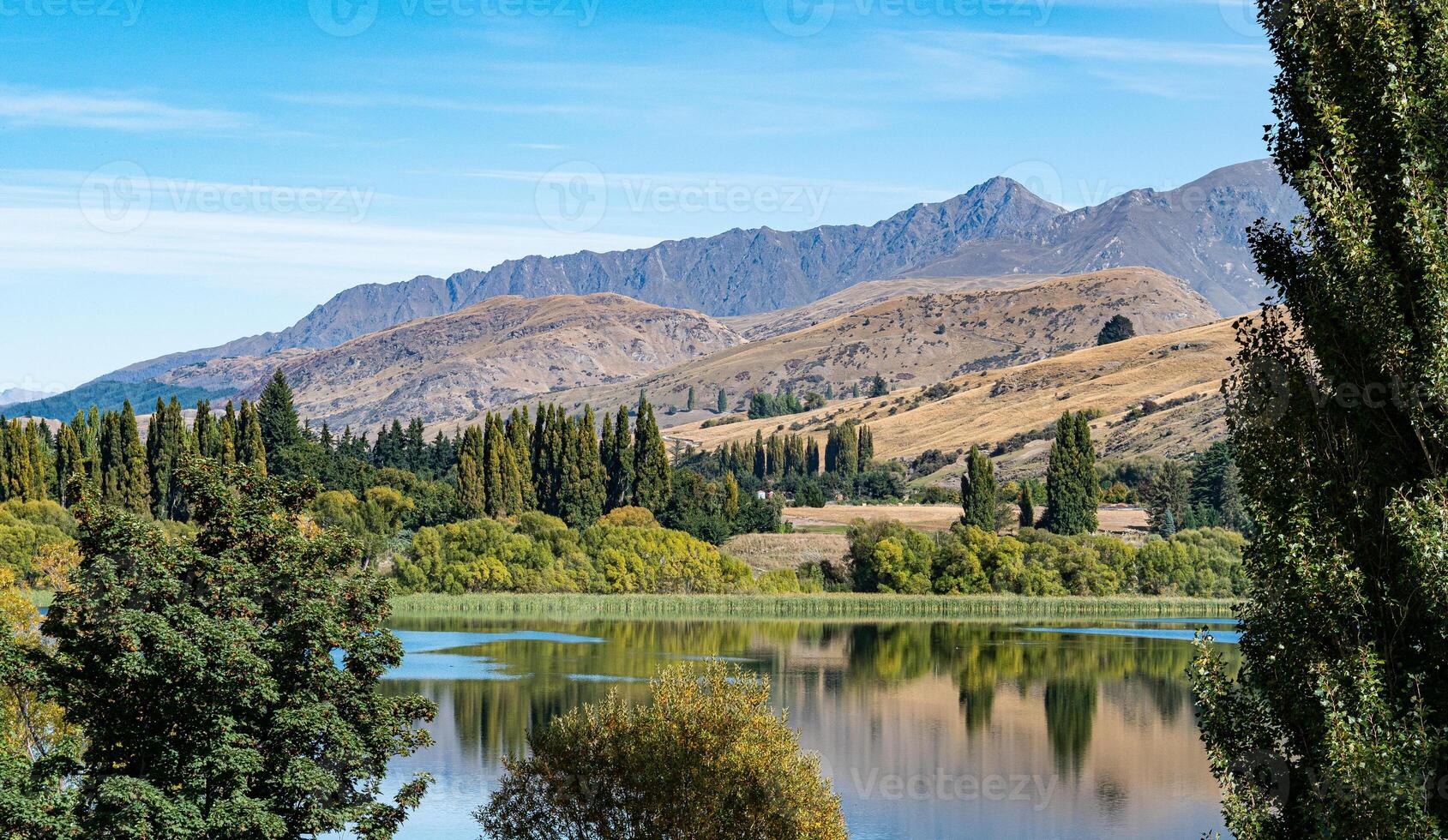 Gorgeous views of lake hayes in New zealand clear day hills photo