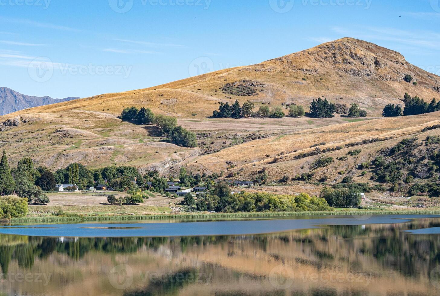 Gorgeous views of lake hayes in New zealand clear day hills photo