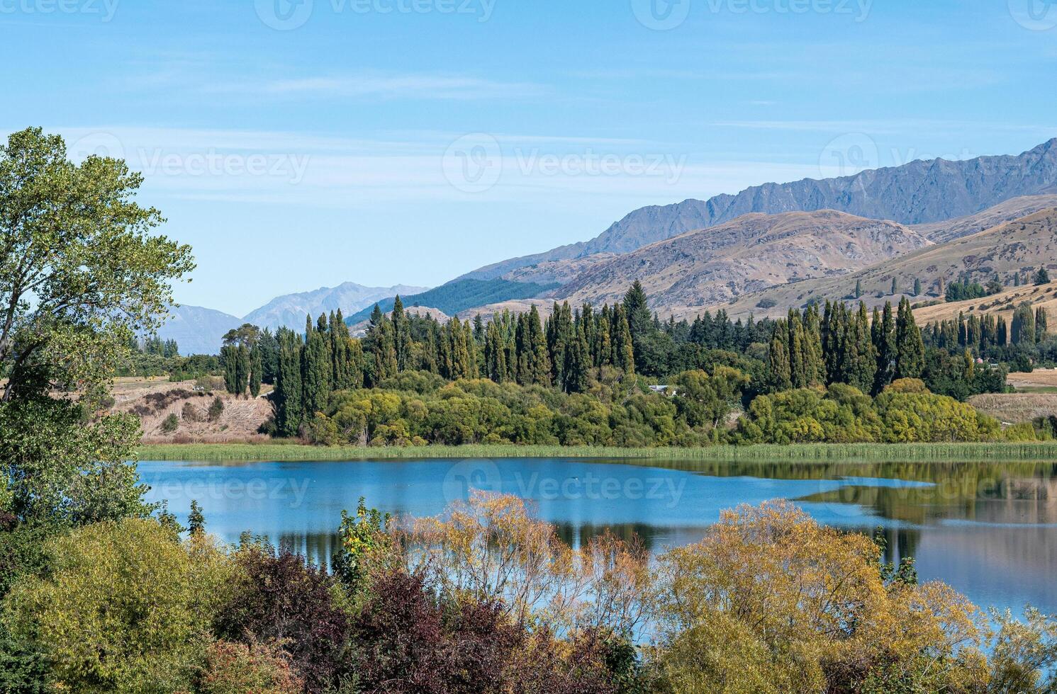 Gorgeous views of lake hayes in New zealand clear day hills photo