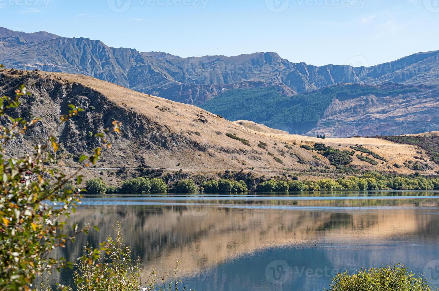 Gorgeous views of lake hayes in New zealand clear day hills photo