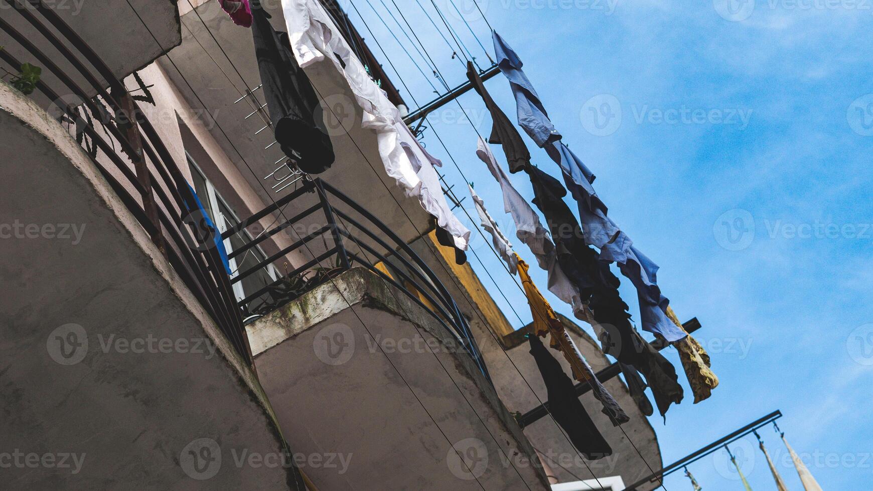 Clothing drying on a balcony outside residential building house photo