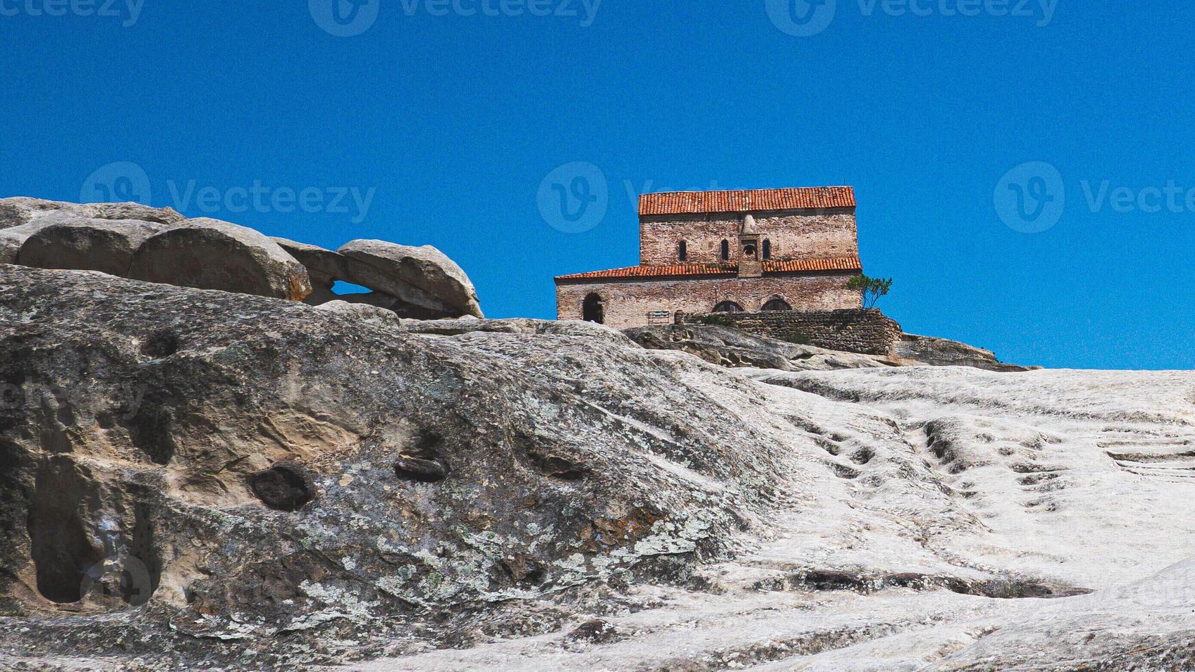 Views of uplistsikhe ancient rock town in country of Georgia stone walls photo