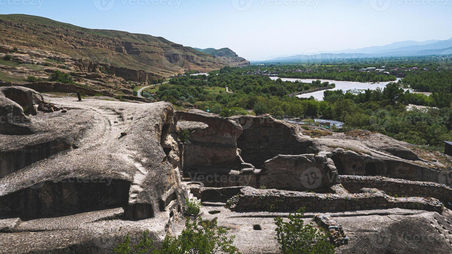 Views of uplistsikhe ancient rock town in country of Georgia stone walls photo
