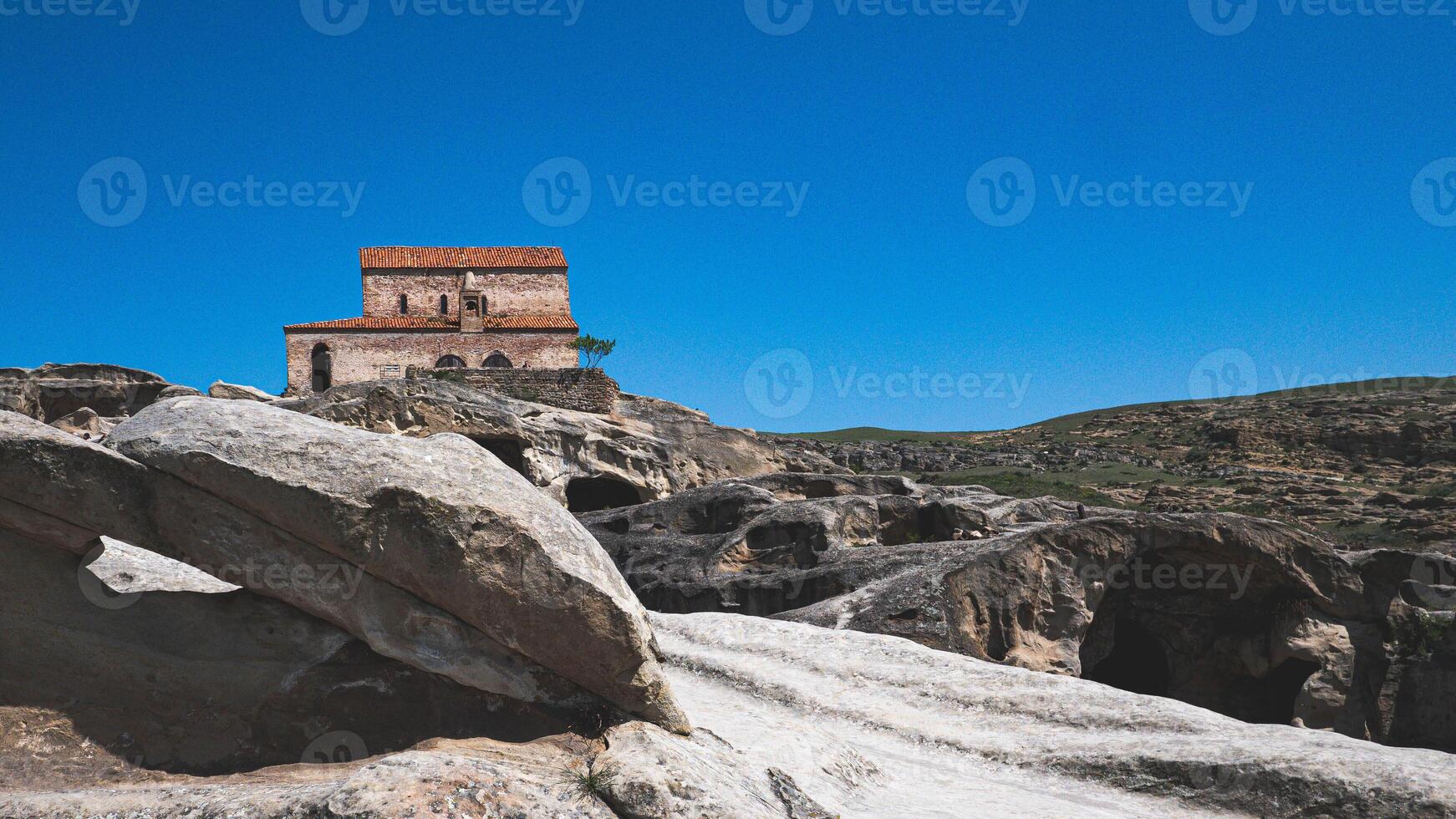 Views of uplistsikhe ancient rock town in country of Georgia stone walls photo