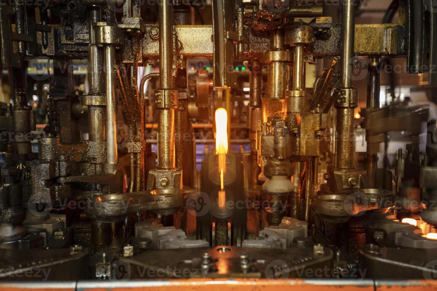 Glassworks. Glass industry. Burning blanks of glass bottles in an industrial stove photo