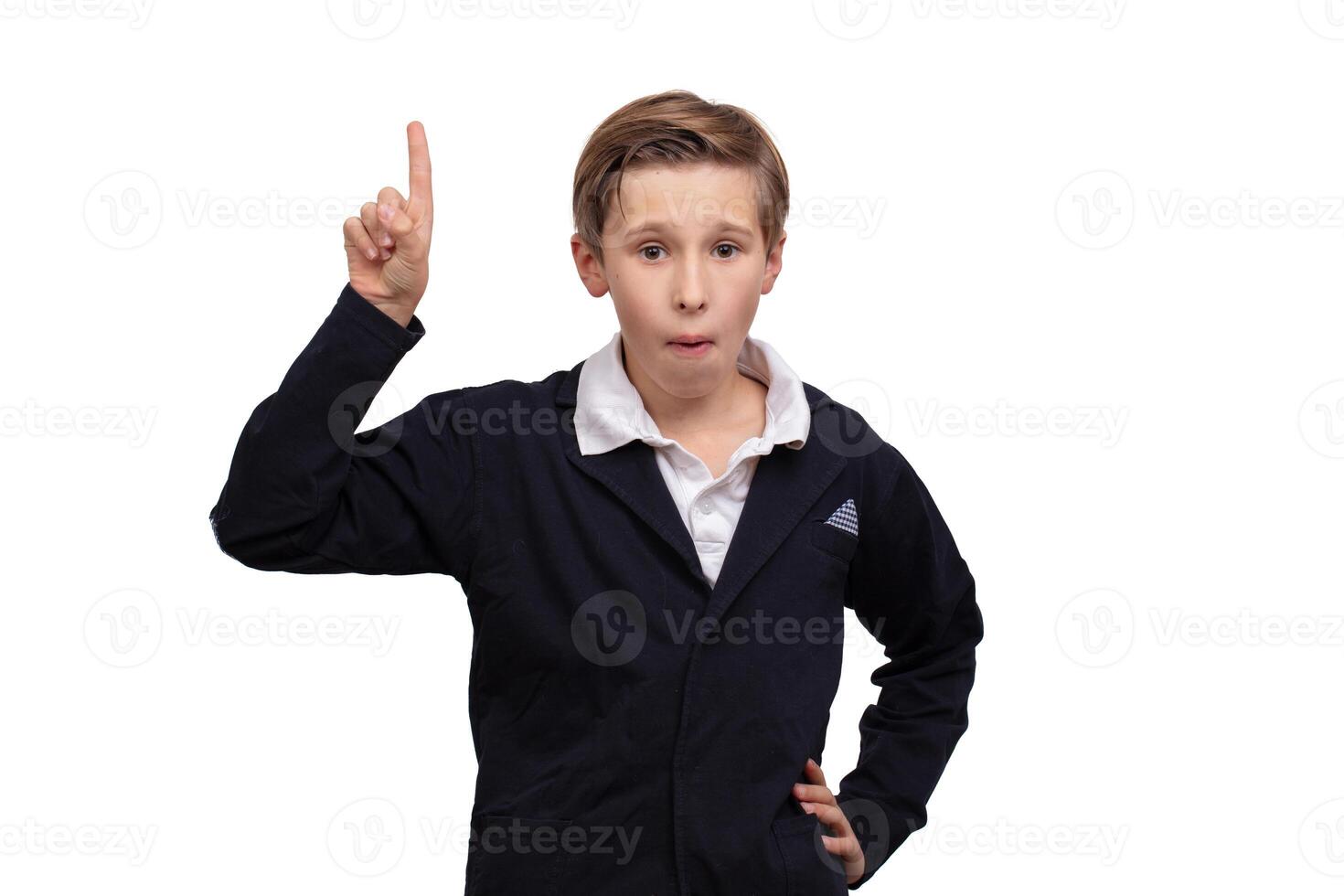 A schoolboy boy raised his finger up. A concept is an idea. photo