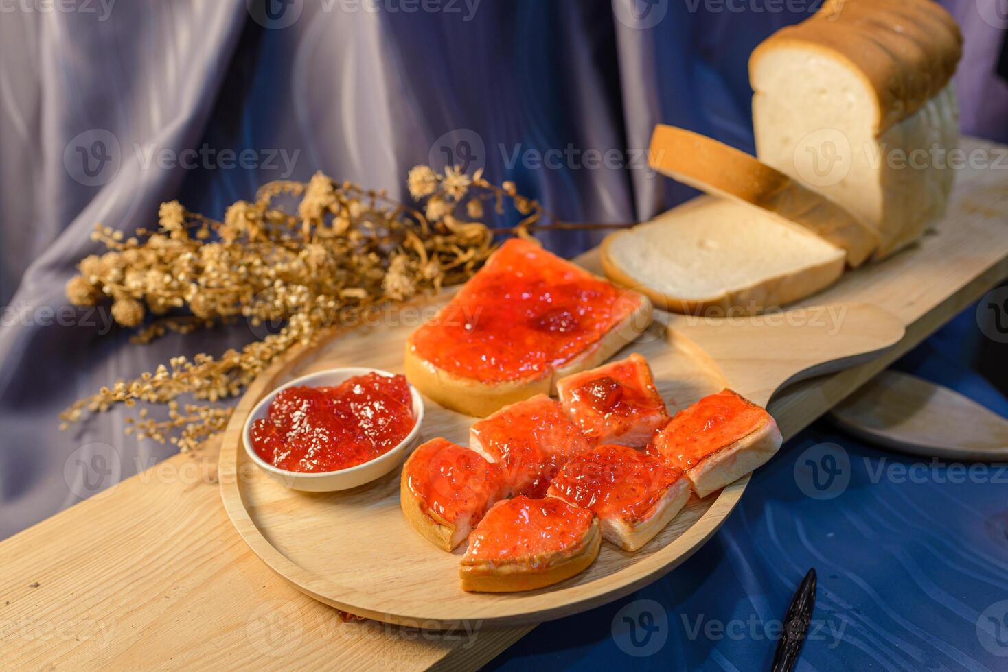 A wooden tray with bread, jam and jelly photo
