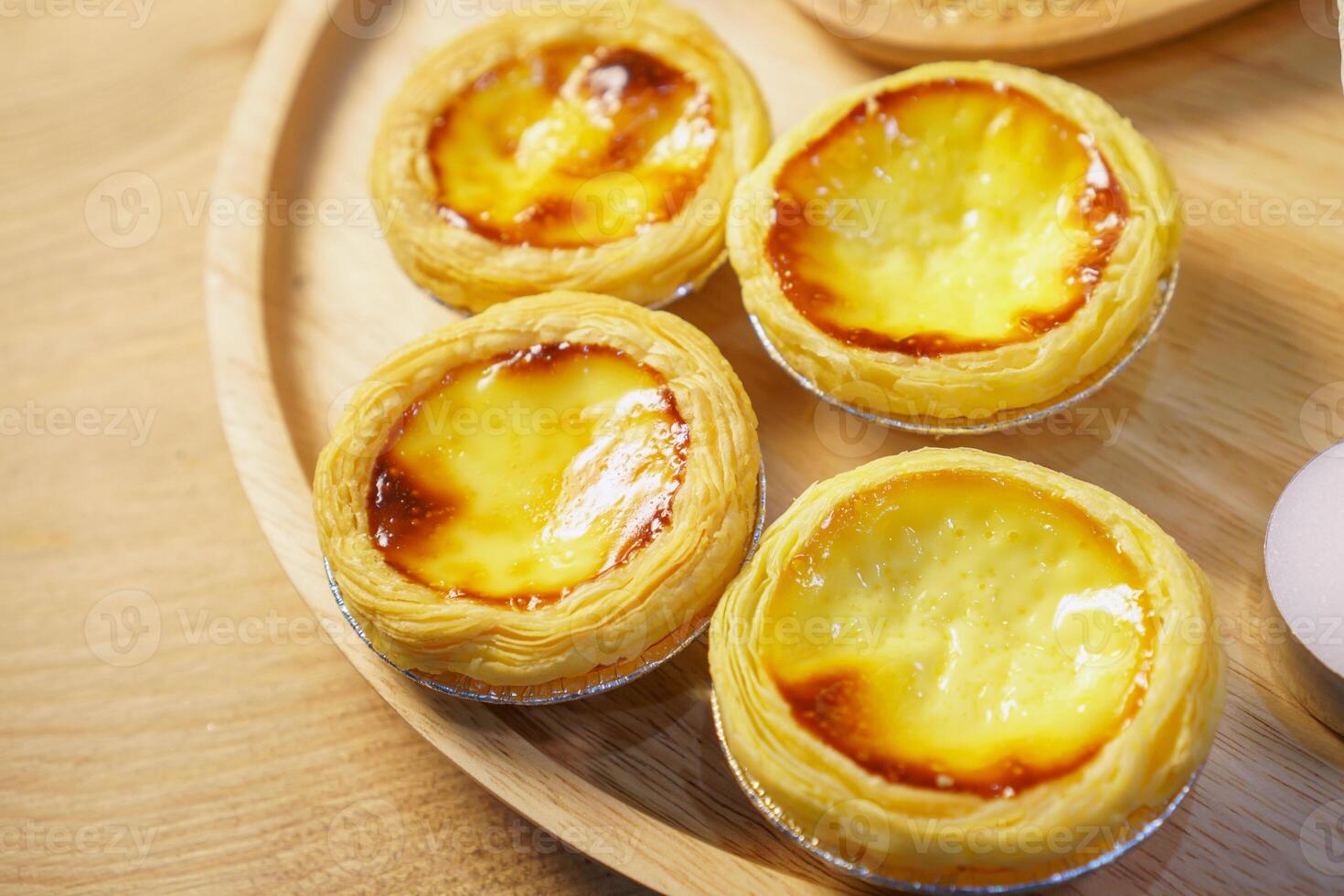 A wooden tray topped with four mini pies photo