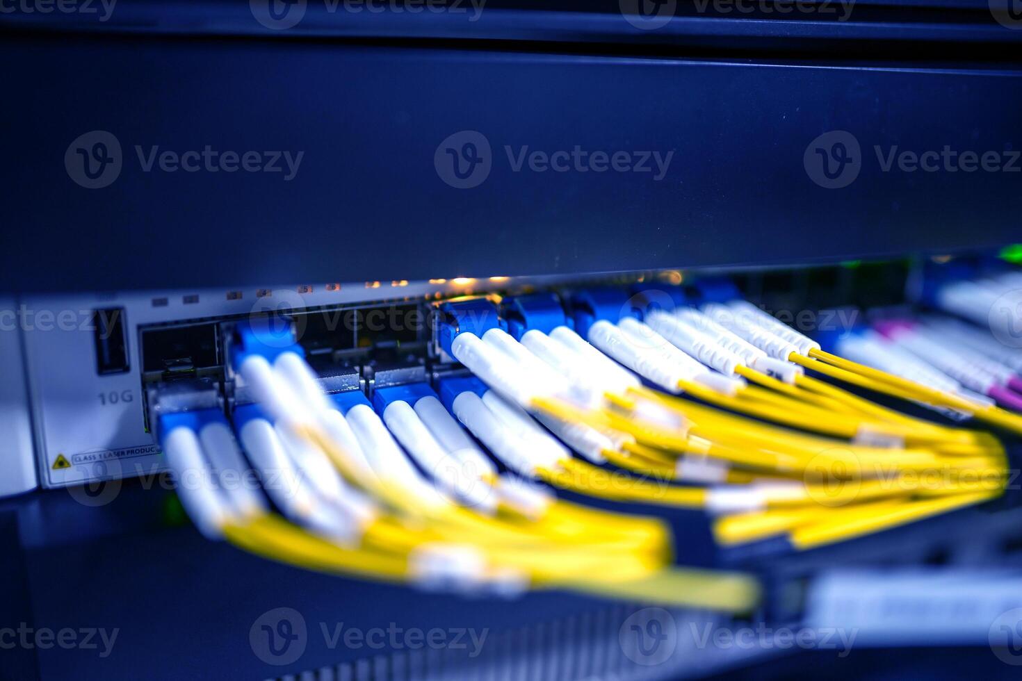A close up of a network switch with yellow and blue wires photo