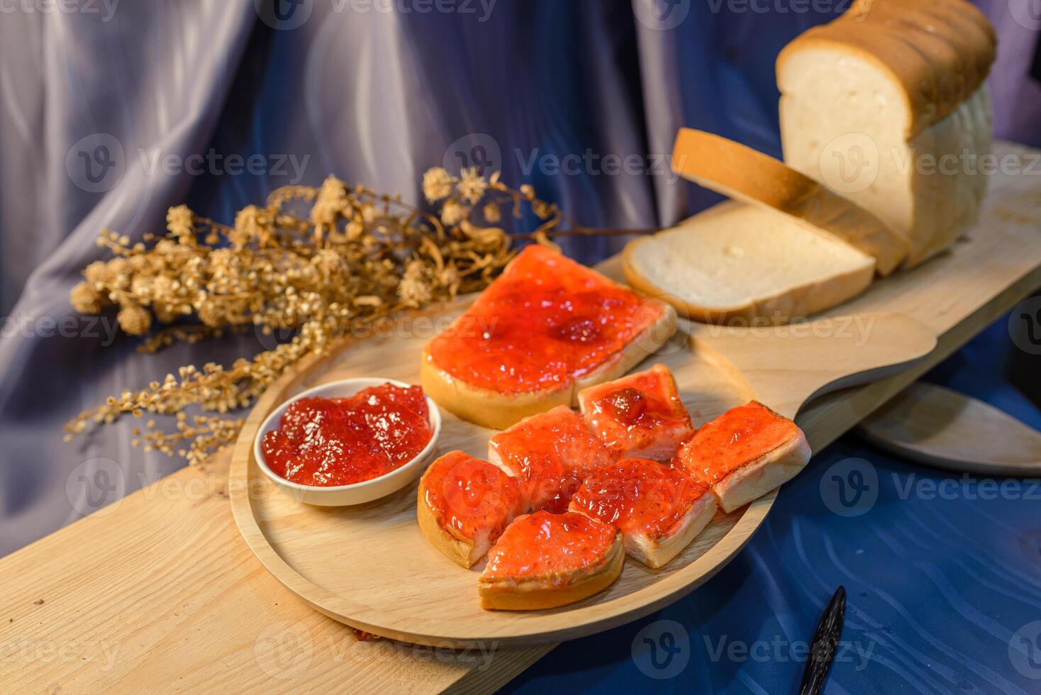 A wooden tray with bread, jam and jelly photo